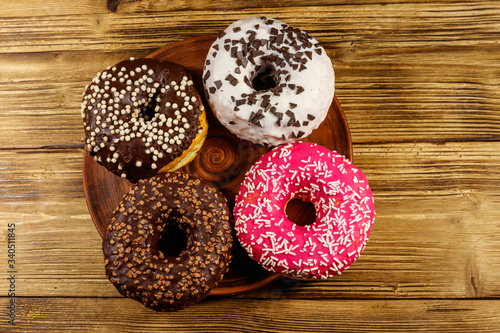 Tasty donuts on a wooden table. Top view