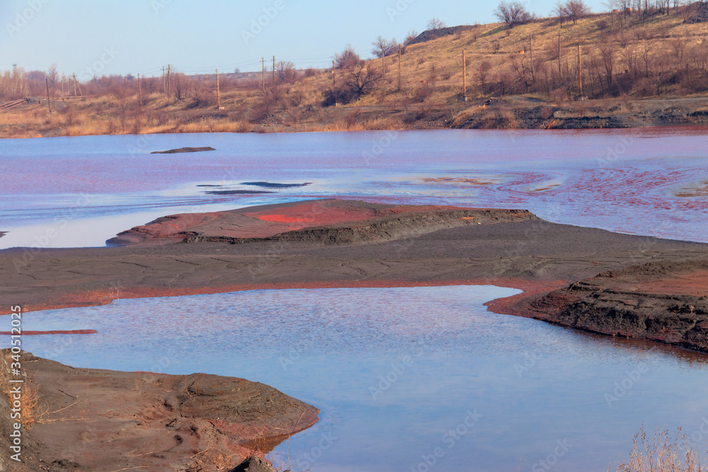 Technical settler of industrial water of mining industry in Kryvyi Rih, Ukraine. Red water polluted with iron ore waste