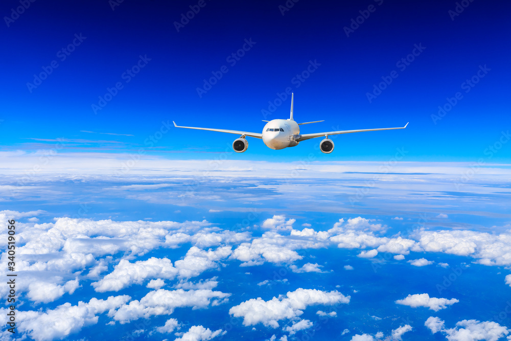 Commercial airplane flying above the clouds,travel concept.
