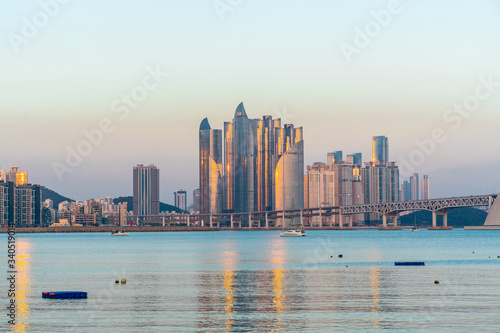 Sunset in Busan, South Korea on a sunny winter day with light reflecting of the buildings. © Mick Go