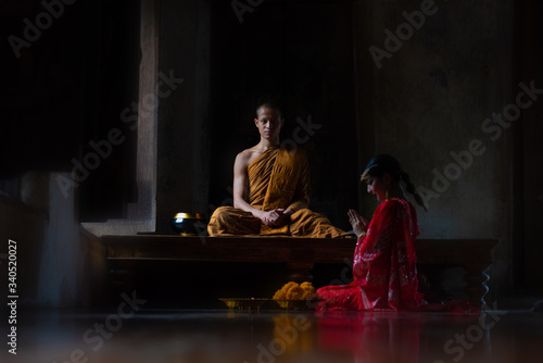 Girl wearing Indian clothes and monks in temple