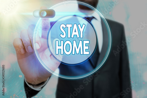 Conceptual hand writing showing Stay Home. Concept meaning not go out for an activity and stay inside the house or home photo