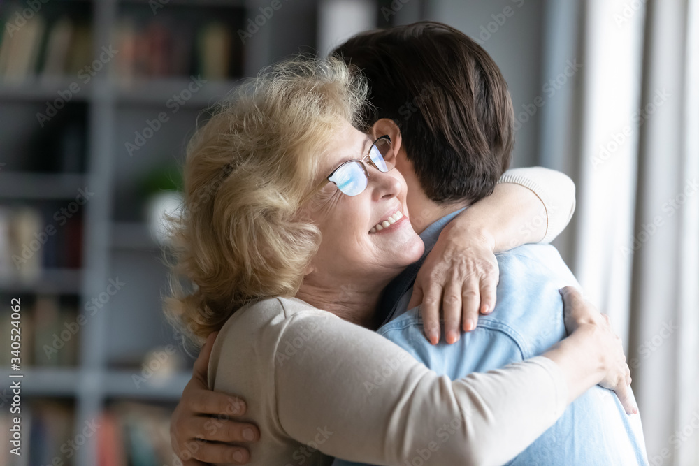 Φωτογραφία Loving elderly mother in glasses closed eyes enjoy moment strong cuddles adult s