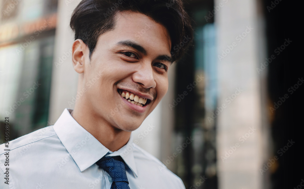 Headshot of Happy Urban Businessman in the City. Young Friendly Man. Looking at the Camera Headshot of Happy Urban Businessman in the City. Young Friendly Man. Looking at the Camera