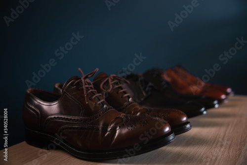 Men Footwear Fashion. Variety of Male’s Shoes on Shelf in House. Formal Leather Shoes, included Wingtip, Loafer and Oxford