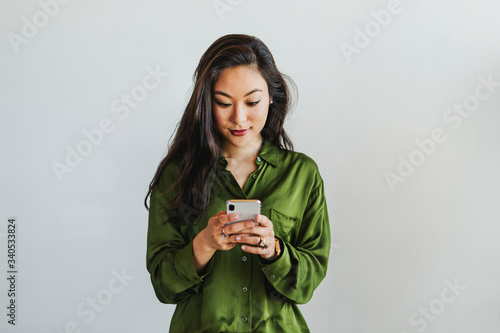 Happy woman texting on a phone