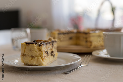 Festive cheesecake on the table with a cup of coffee. Easter time.