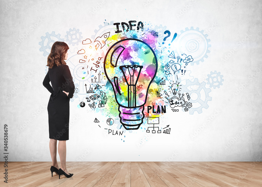 Businesswoman looking at business idea sketch