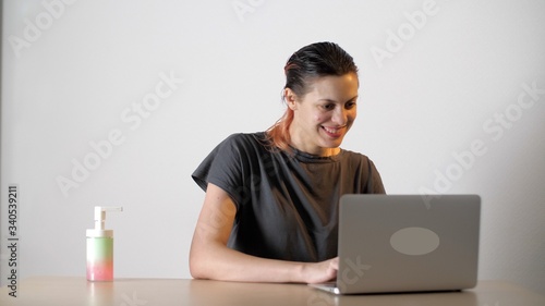 Nice girl communicates online with her boyfriend. Date online. Beautiful woman flirts with a guy through a video chat in laptop during quarantine due to coronavirus. Self isolation.