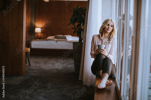 Young woman with cup of tea...