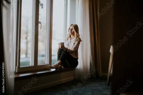 Young woman with cup of tea...