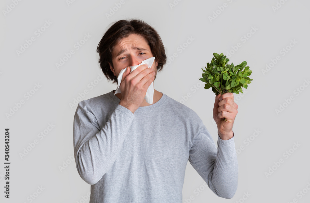 Allergic to product concept. Guy wipes his nose Allergic to product concept. Guy wipes his nose