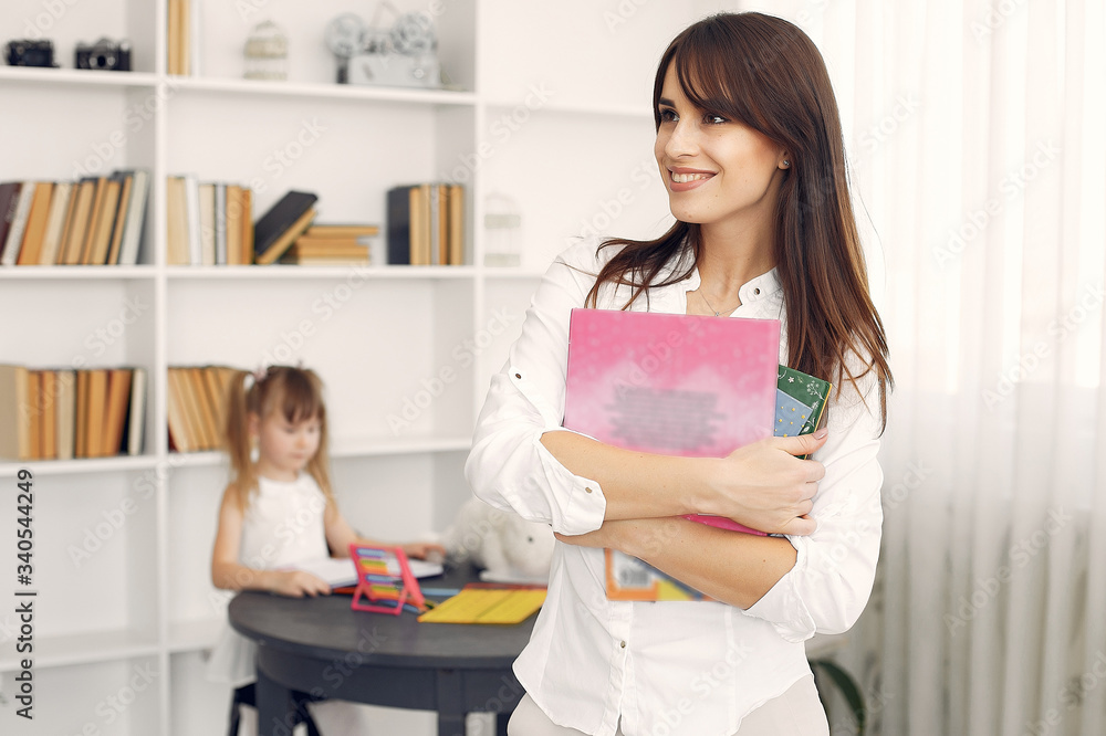 Tutor with pupil. Little girl studying. Private lesson. Tutor with pupil. Little girl studying. Private lesson.