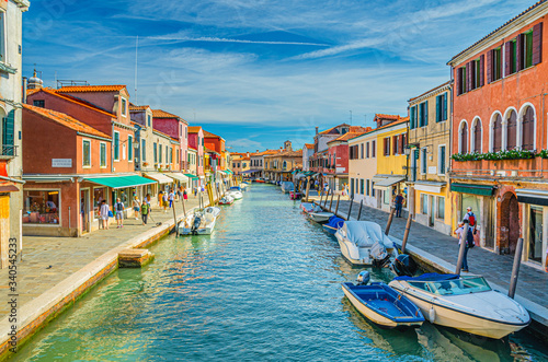 Murano islands with water canal, boats and motor boats, colorful traditional buildings, Venetian Lagoon, Province of Venice, Veneto Region, Northern Italy. Murano postcard cityscape. © Aliaksandr