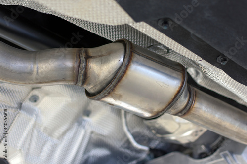 Catalytic converter of a modern car bottom view.	 photo