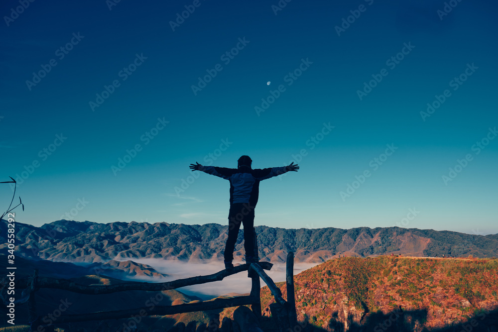 silhouette of a woman on the top of mountain