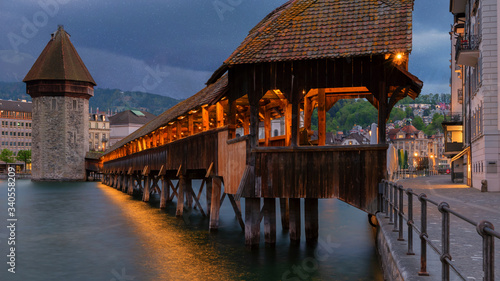 Kapellbrucke Panorama night view Historic Chapel bridge (Famous covered wooden footbridge), Water Tower, Chateau Gutsch, Jesuitenkirche over Reuss river Cityscape old town under Blue Sky, Switzerland photo