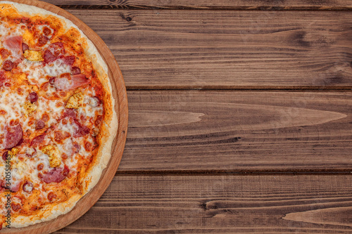 Pizza with Mozzarella cheese, salami, Tomatoes, pepper, Spices. Italian pizza