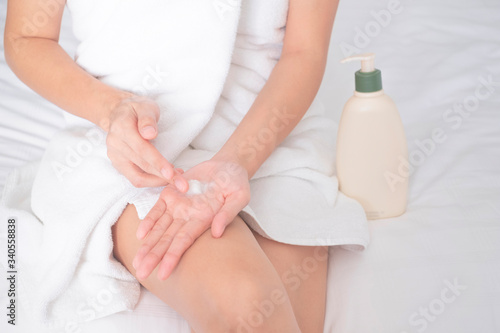 Woman applying moisturizing cream/lotion on hands, beauty concept..