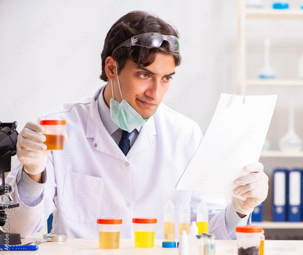 Young handsome chemist working in the lab Young handsome chemist working in the lab