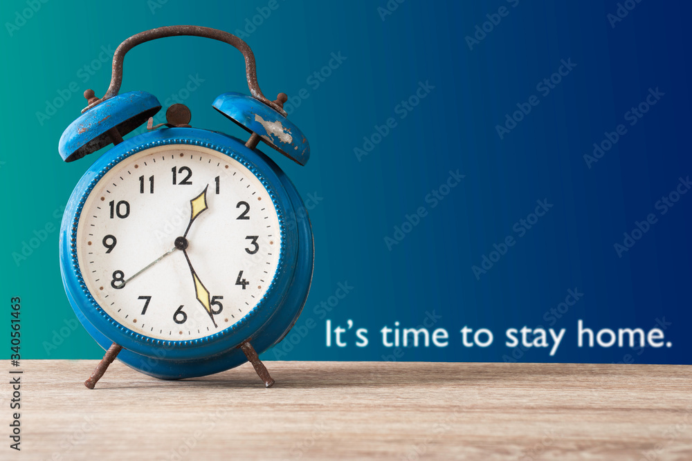 An antique clock is on a wood table with the sentence: An antique clock is on a wood table with the sentence: