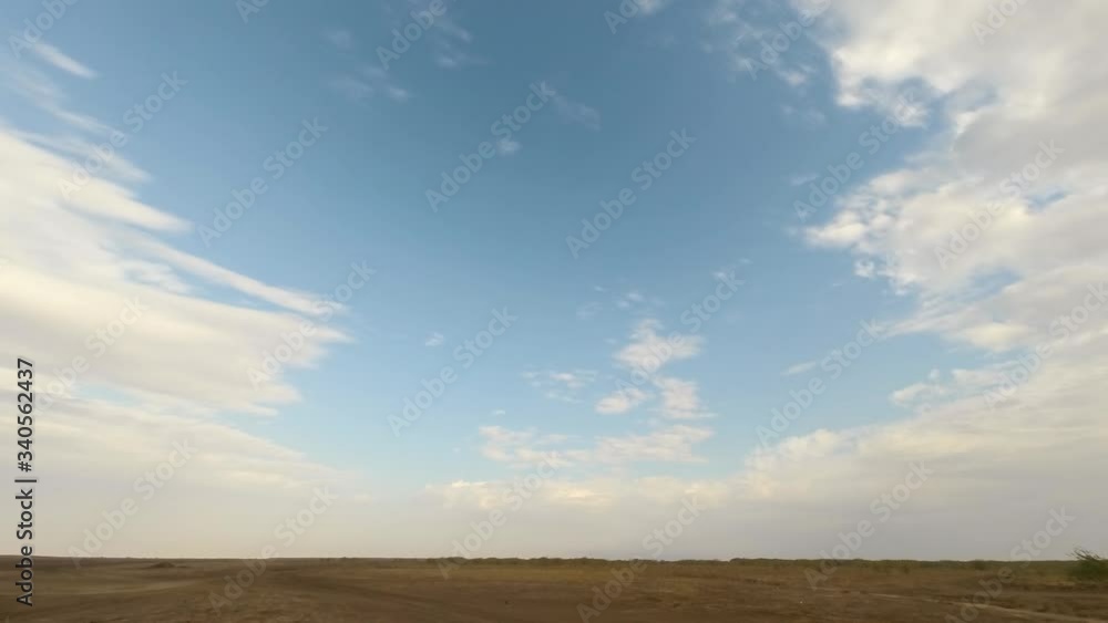 Time lapse during late afternoon in the Little Rann of Kutch a flat landscape and amazing cloud movement in Gujarat India Time lapse during late afternoon in the Little Rann of Kutch a flat landscape and amazing cloud movement in Gujarat India