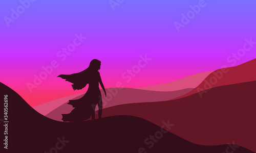 vector illustration of a silhouette of a girl with flowing hair in a dress in the desert at dawn © art_vor