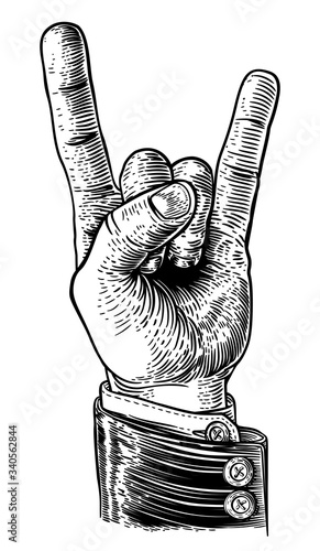 A hand in business suit doing a heavy metal rock music sign gesture in a vintage woodcut retro style