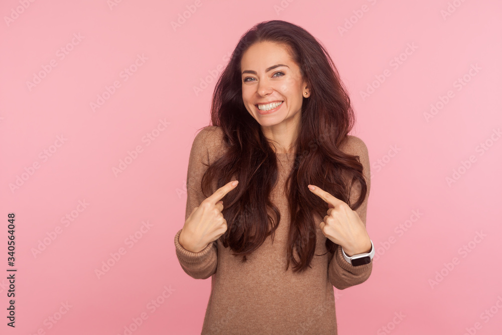 This is me, I am awesome! Portrait of happy young woman with brunette wavy hair pointing herself and smiling excitedly, expressing great joy and pride in her achievements. indoor studio shot isolated This is me, I am awesome! Portrait of happy young woman with brunette wavy hair pointing herself and smiling excitedly, expressing great joy and pride in her achievements. indoor studio shot isolated