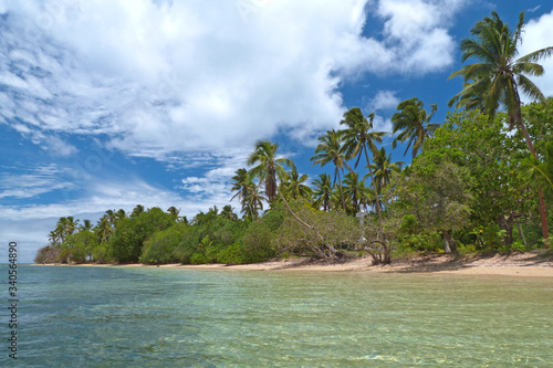 Tropical coral island with torquoise water, sandy beach and coconut palm trees, Pangaimotu, Tonga photo