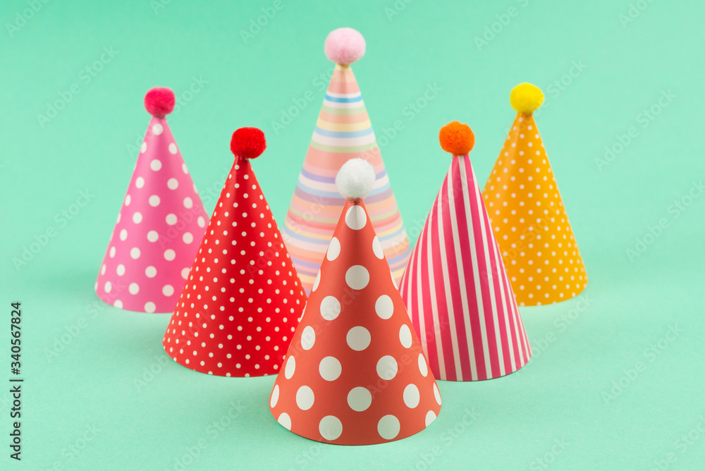 Colorful birthday caps on mint background. Colorful birthday caps on mint background.