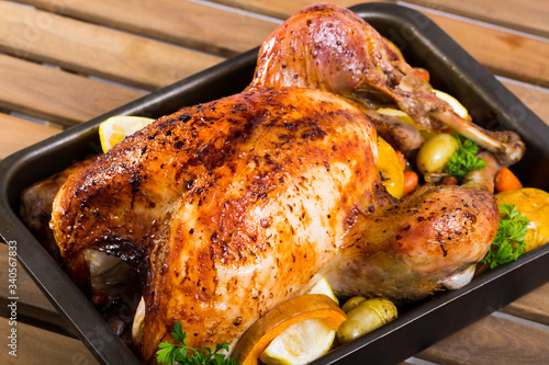 Close up of tasty baked turkey with apples, lemon and herbs