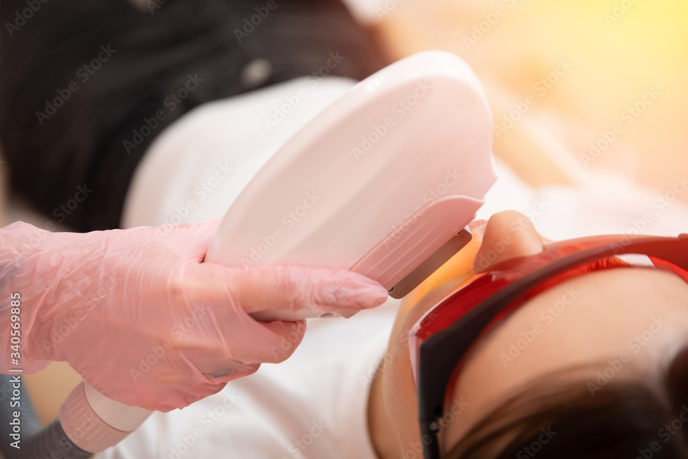 Naklejka premium Removal of unwanted hair laser Epilation on face mustache young woman. Concept beauty and health