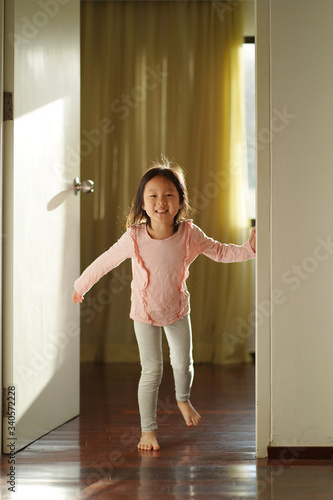 Fototapeta Naklejka Na Ścianę i Meble -  Asian chinese girl dashing out of her bedroom