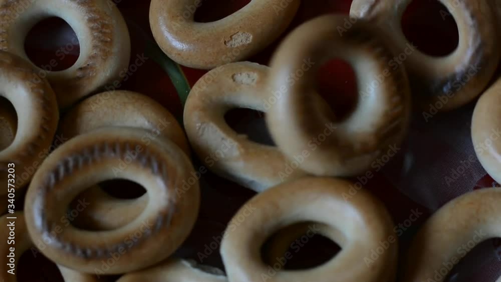 Small bagels are poured onto a red plate. Small bagels are poured onto a red plate.