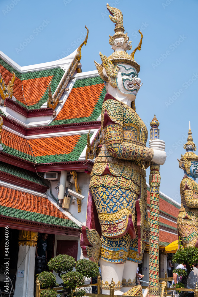 Large sculptures depicting guardians in front of temple doors at Wat Phra Kaew, the Temple of the Emerald Buddha
