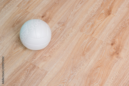 Close Up Of Volleyball Ball On Wooden Floor.