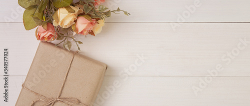 Beautiful flower and gift box on wooden background with romantic, presents for mother day or valentine day with pastel tone, decoration on desk, holiday concept, banner website.