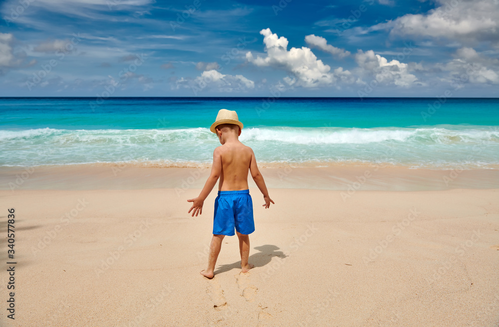 Three year old toddler boy walking on beach Three year old toddler boy walking on beach