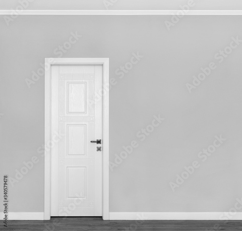 Fototapeta Naklejka Na Ścianę i Meble -  Beautiful wooden white door on empty grey wall with copy space for your text.