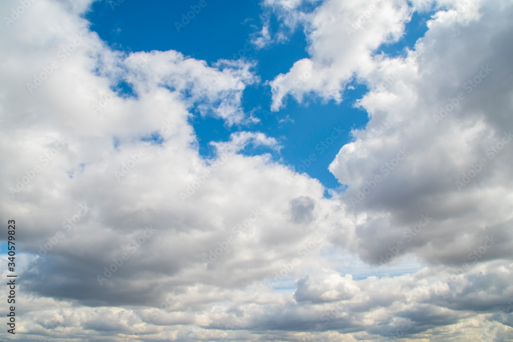 Background with blue sky with lots of white clouds Background with blue sky with lots of white clouds