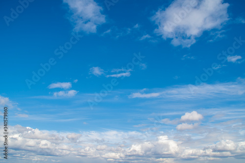 Background with blue sky with lots of white clouds © Николай Батаев
