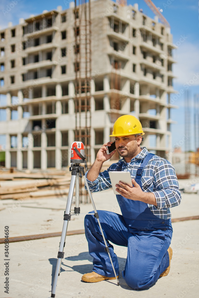 An engineers uses measuring equipment at his work place. An engineers uses measuring equipment at his work place.