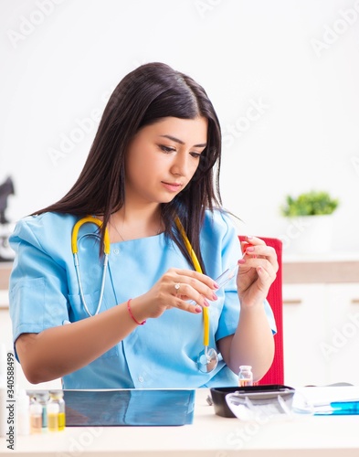 Young beautiful female doctor working in the clinic
