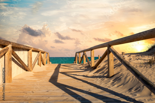 wooden access to the beach on the sand dunes at sunset. Guardamar  Alicante.Spain