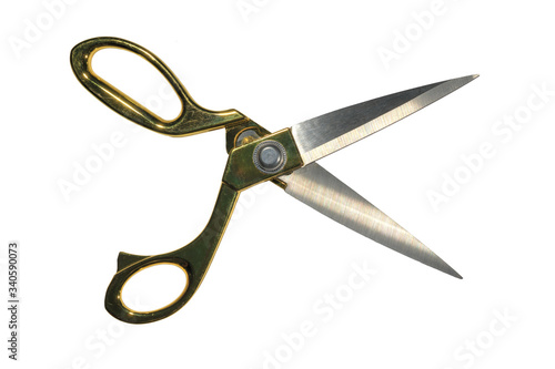 A pair of crafting scissors with gold-colored handles. Isolated on white