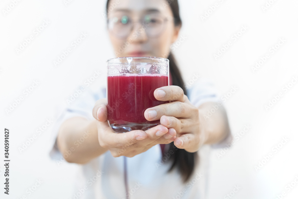 A cute girl makes vegetable juice, with carrot apple orange cranberry beetroot and mango in chef suit. A cute girl makes vegetable juice, with carrot apple orange cranberry beetroot and mango in chef suit.