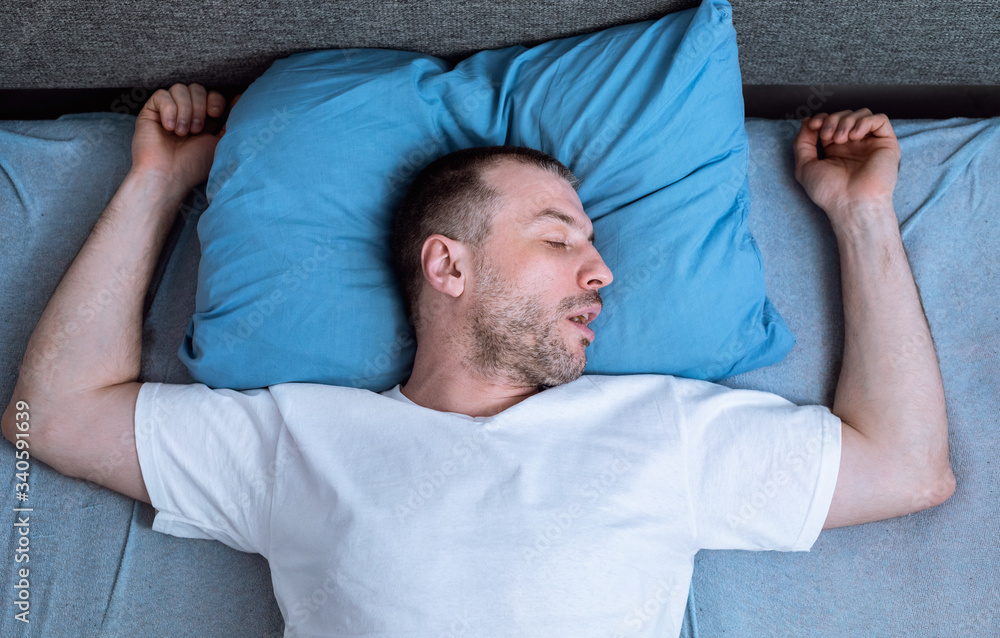 Man Sleeping And Snoring Lying In Bed At Home, Above-View Man Sleeping And Snoring Lying In Bed At Home, Above-View