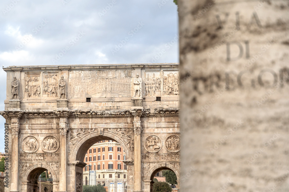 Arch of Constantine or Arco di Costantino and part of Colosseum to right. High Roman structure, triumphal arch, victory over Maxentius at Battle of Milvian Bridge, made up of three decorated arches.