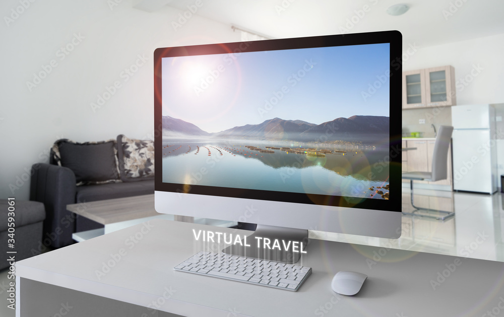 Fototapeta premium Computer with a view of the bay in the mountains on the screen. Virtual travel